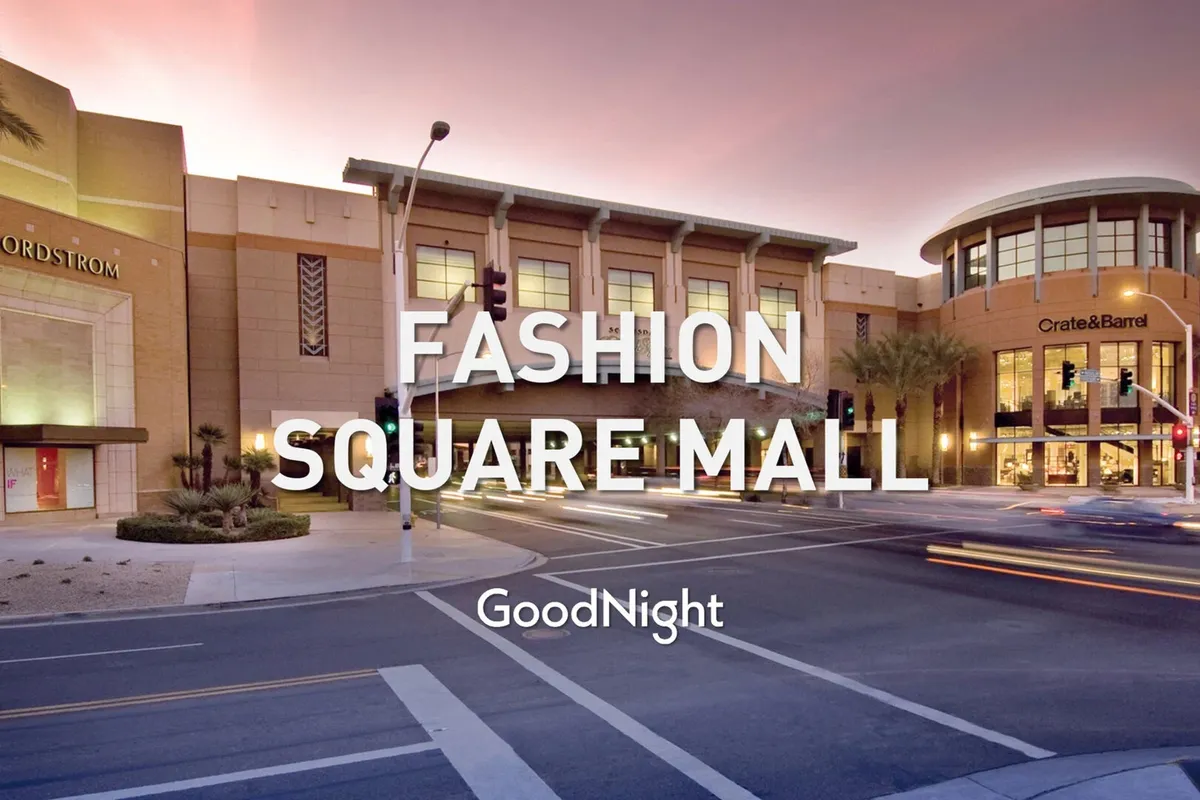 A bustling sidewalk scene outside Scottsdale Fashion Square, featuring the prominent Nordstrom and Crate & Barrel storefronts. The area is lively with shoppers, seasonal decorations, and vibrant urban energy, suggesting high-end retail experiences.