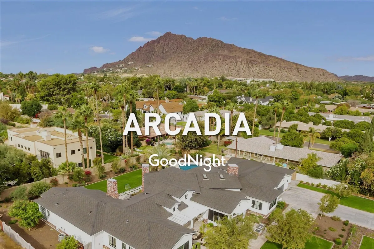An inviting exterior view of the property with a mountain backdrop, lush greenery, a spacious yard, and architectural details of the house. This outdoor scene hints at nearby nature and space for group activities or quiet time.